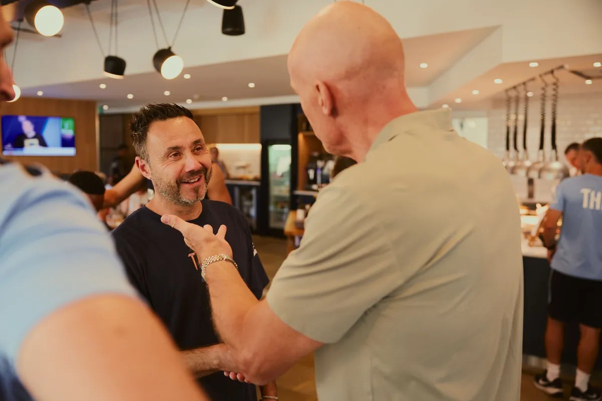 Roberto De Zerbi greeting guests at a Tottenham legends lunch