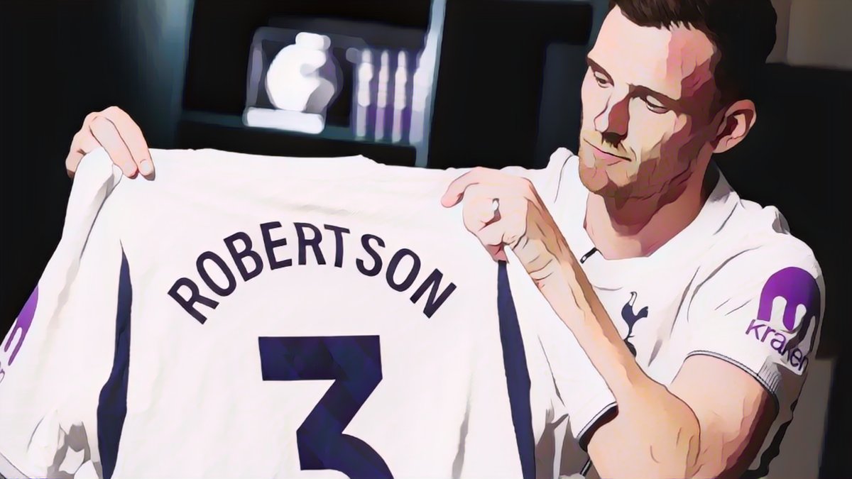 Tottenham player holding up a Robertson shirt
